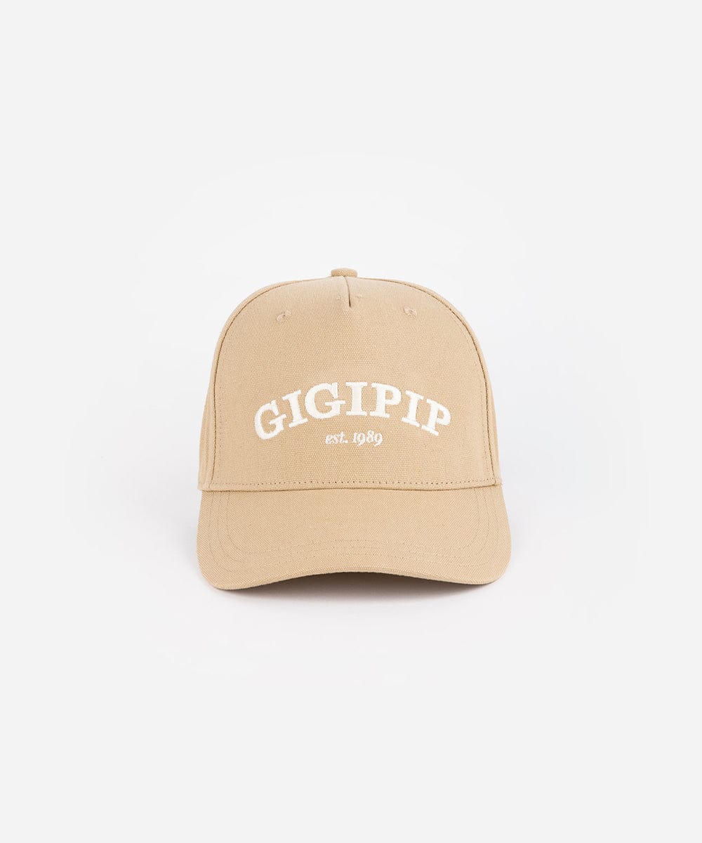 A tan trucker hat with 'GIGI PIP' embroidered in white on the front against a plain background #color_tan
