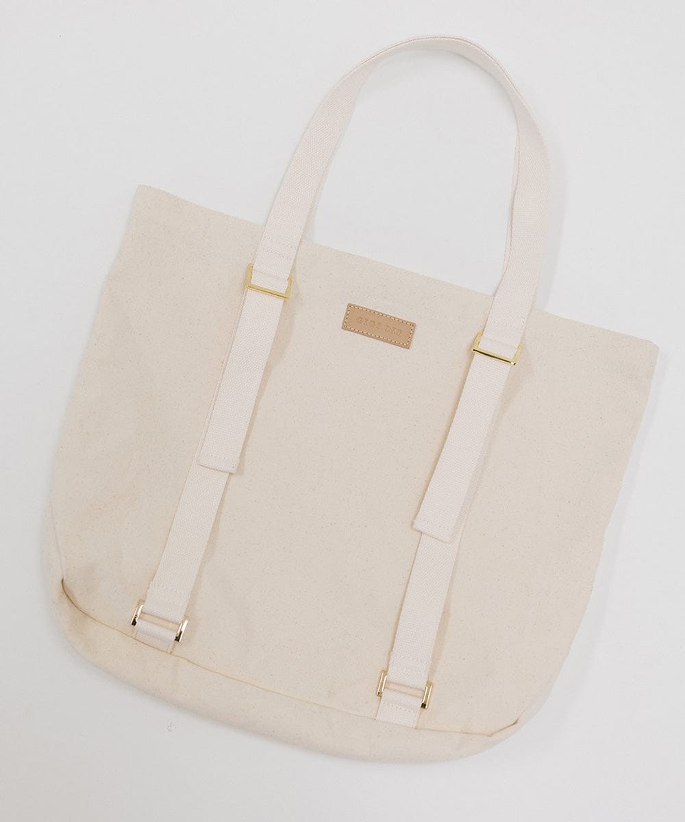 A natural colored canvas tote bag with two adjustable straps designed to carry a hat. #color_natural
