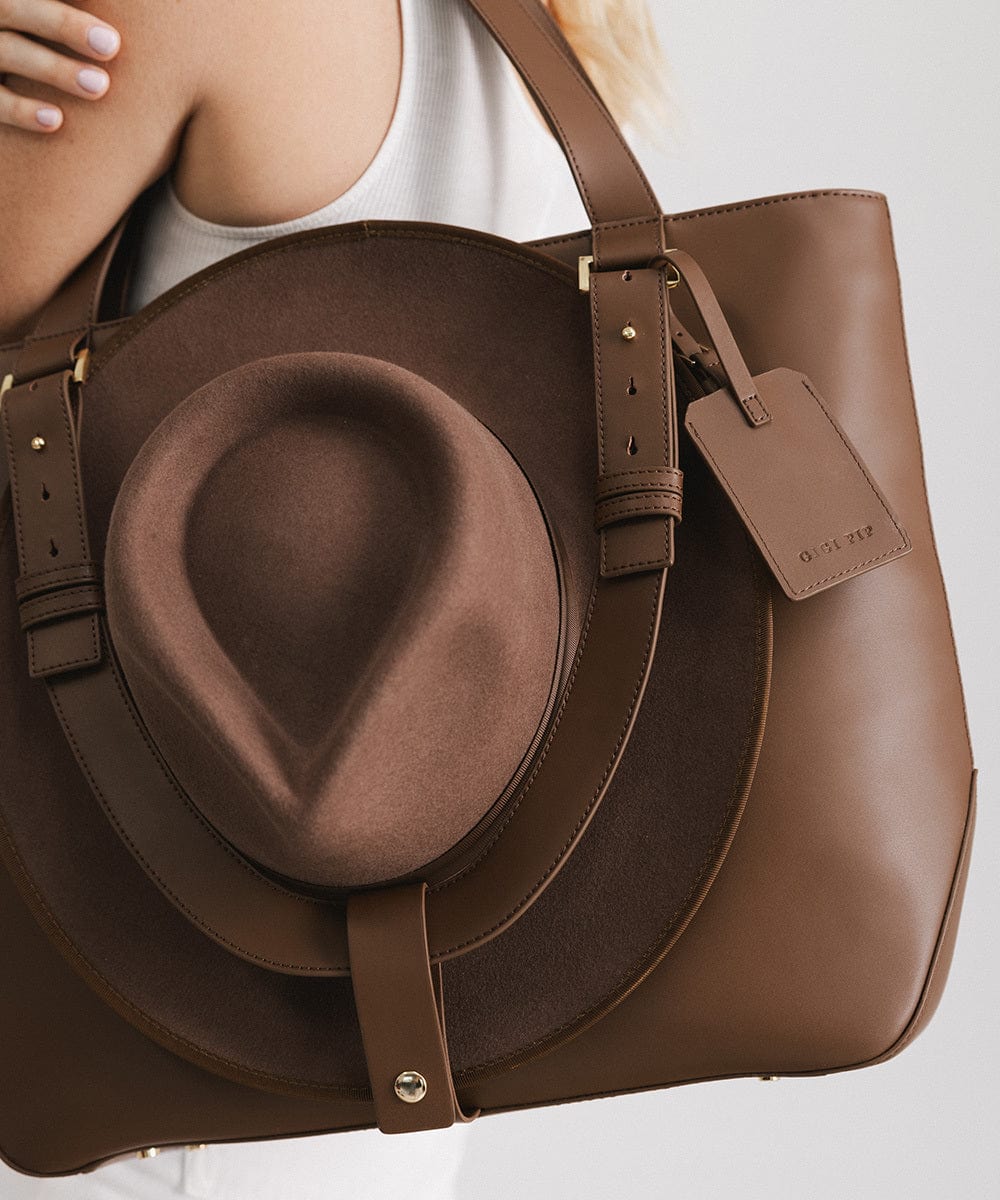 A brown Hayes Hat Carrying Tote made of genuine leather, displayed against a white background. #color_chocolate