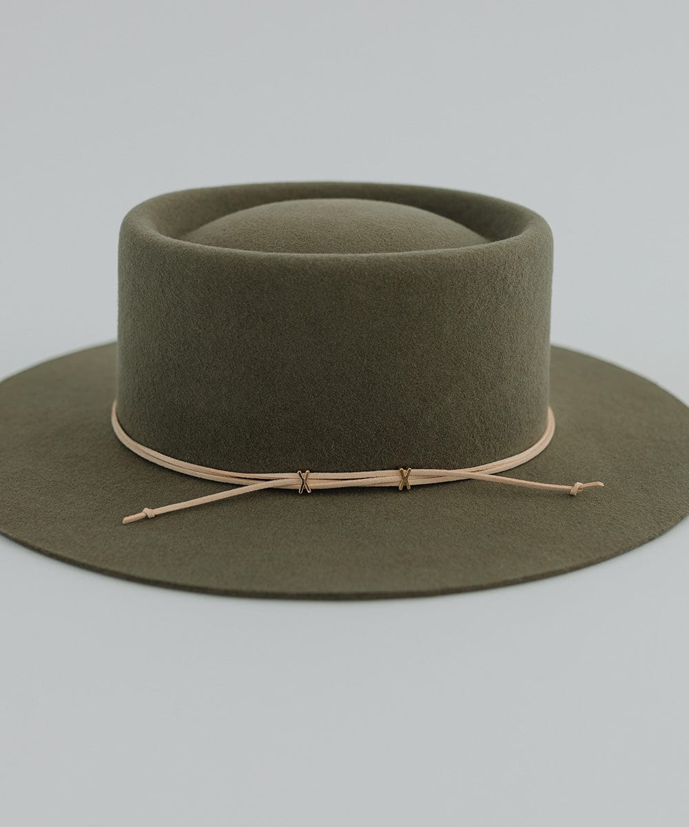 An olive hat with a cream suede xx band on a plain background #color_cream