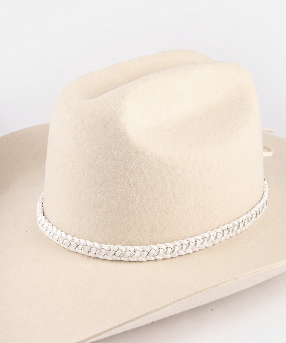 Beige cowboy hat with braided band on a white background #color_off white