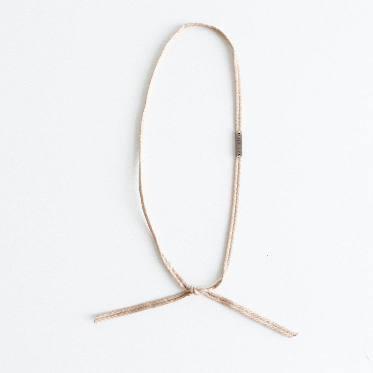 A nude grosgrain band on a plain background #color_nude