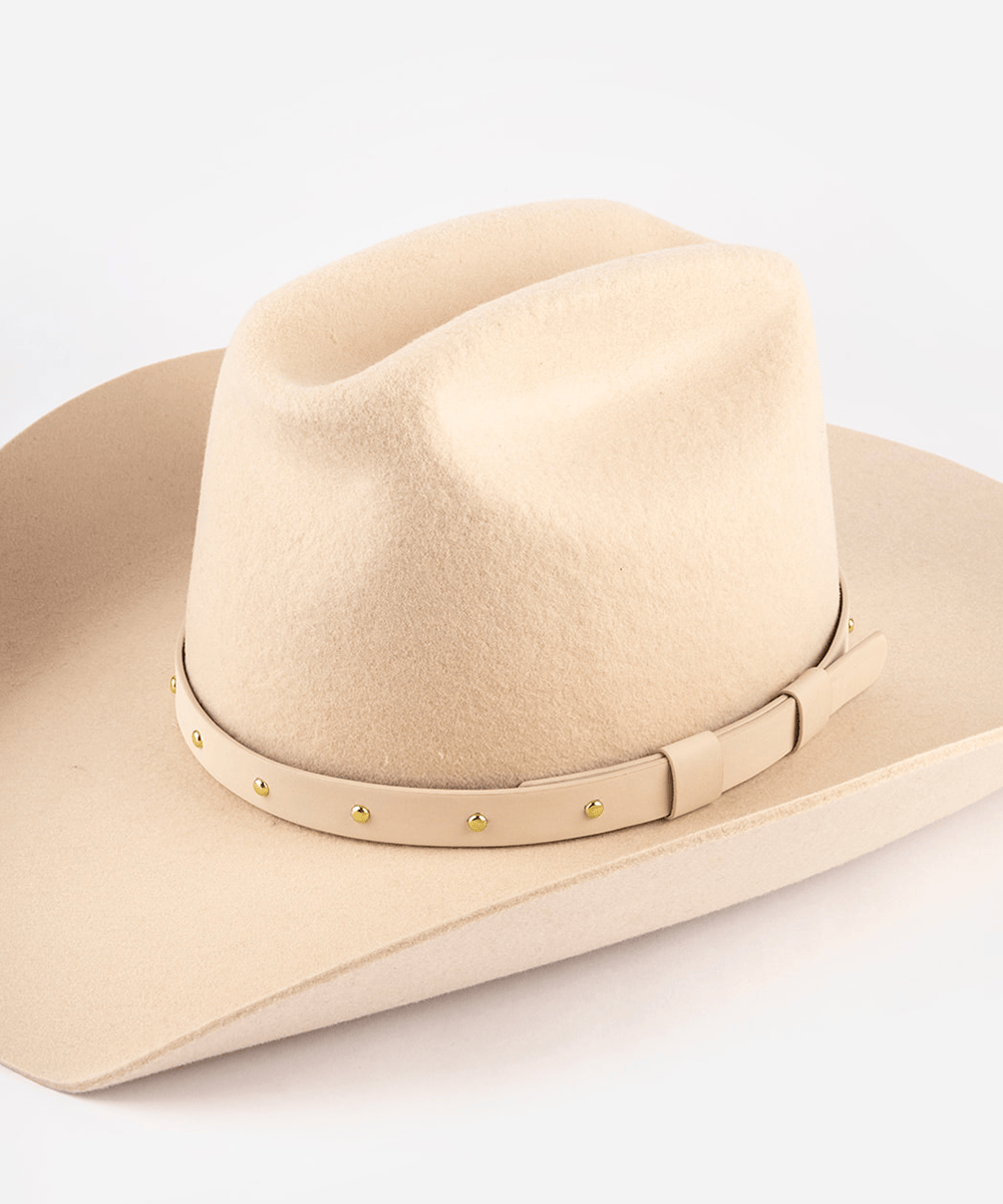Beige cowboy hat with a band on a white background #color_cream-gold