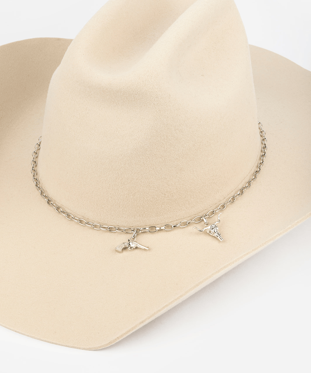 Necklace with charms on a beige cowboy hat against a white background #color_silver