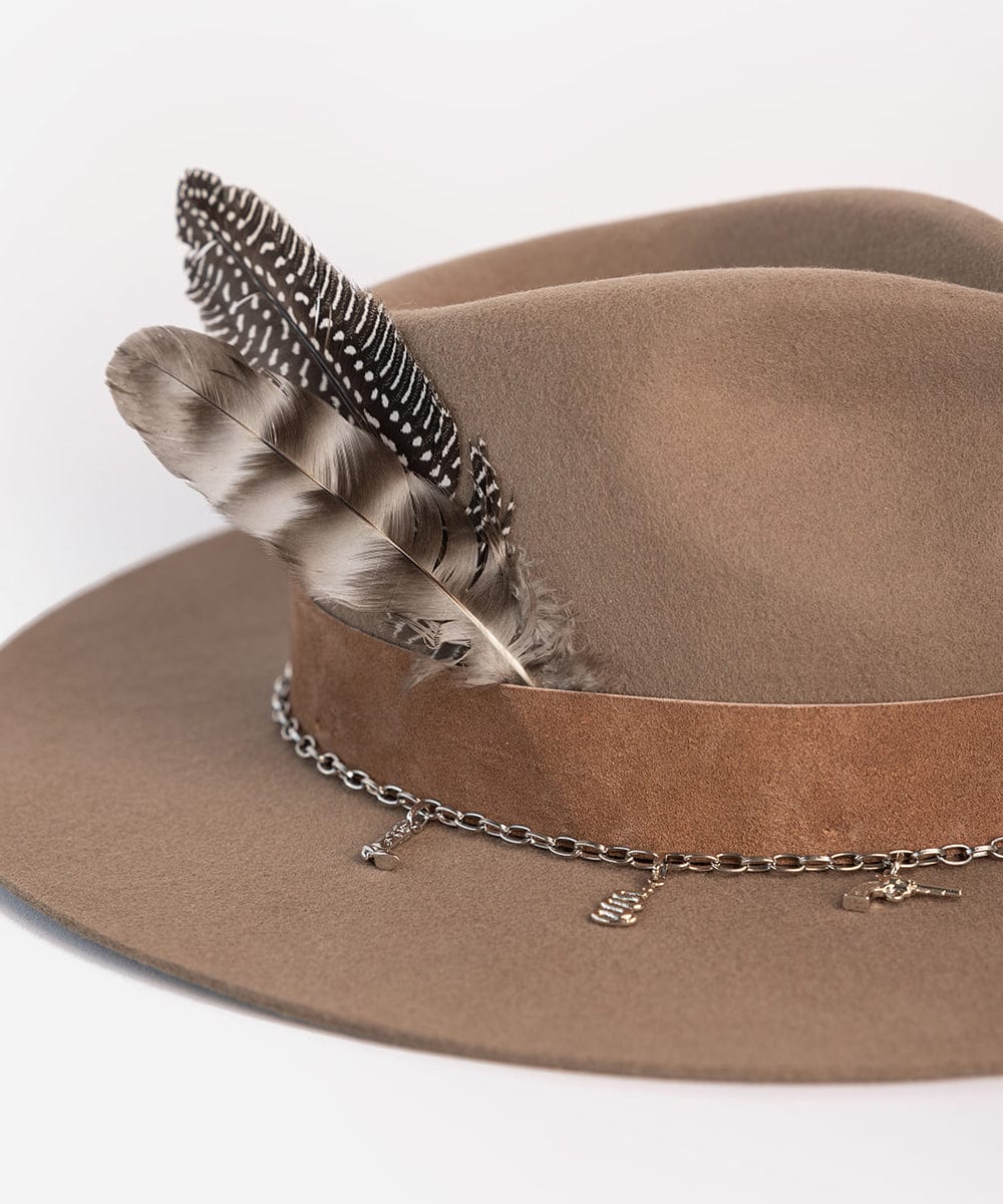A brown cowboy hat with a brown band and a feather along with a silver chain hat band on a plain background #color_silver