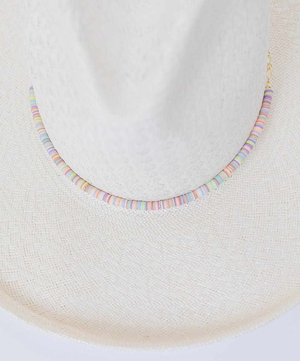 A white hat with a multi colored beaded hat band against a plain background #color_multi