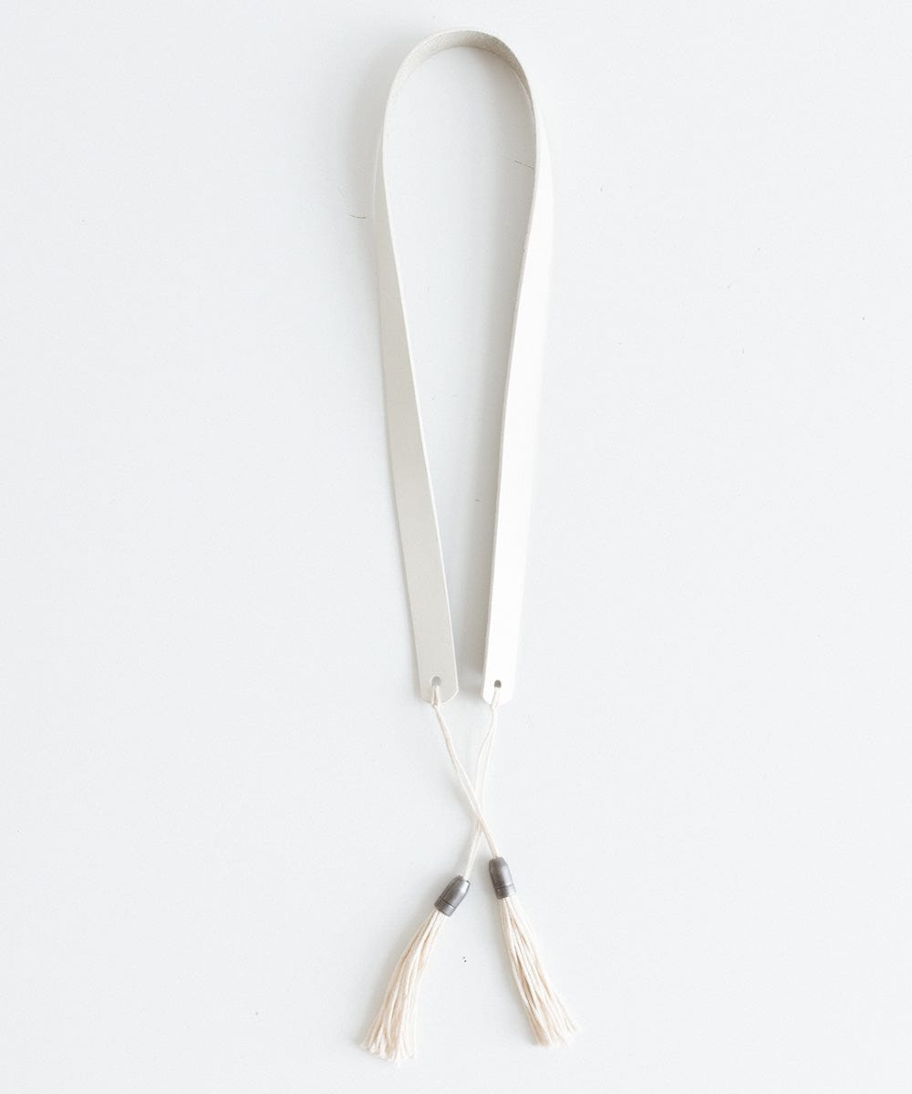 An off white leather band with tassels on a white background #color_off white