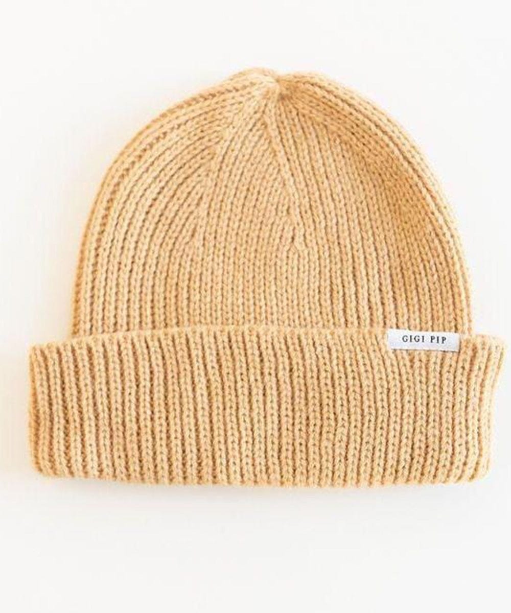 A camel colored knit beanie with the brand label on a white background #color_camel
