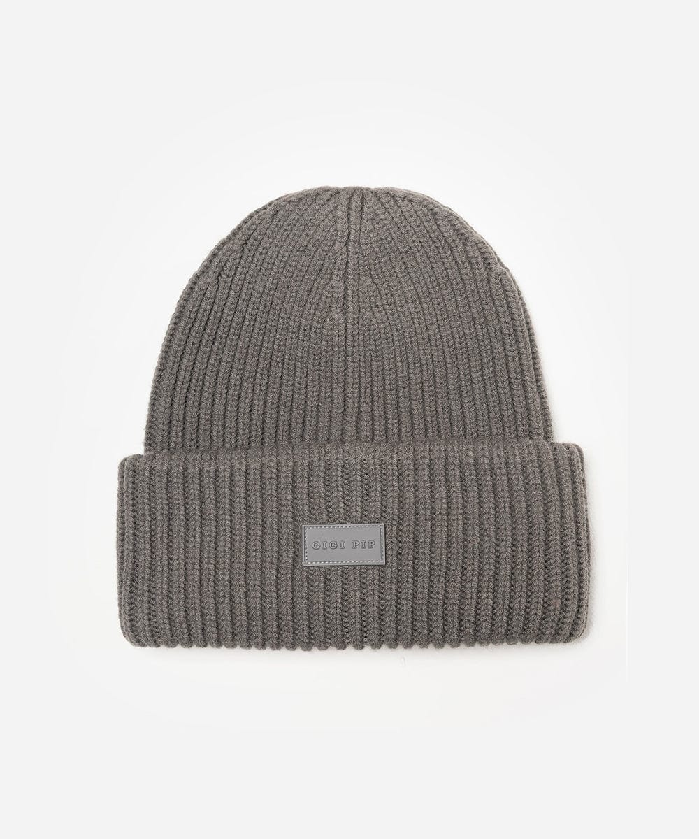 Gray knit beanie with a label on a white background #color_grey