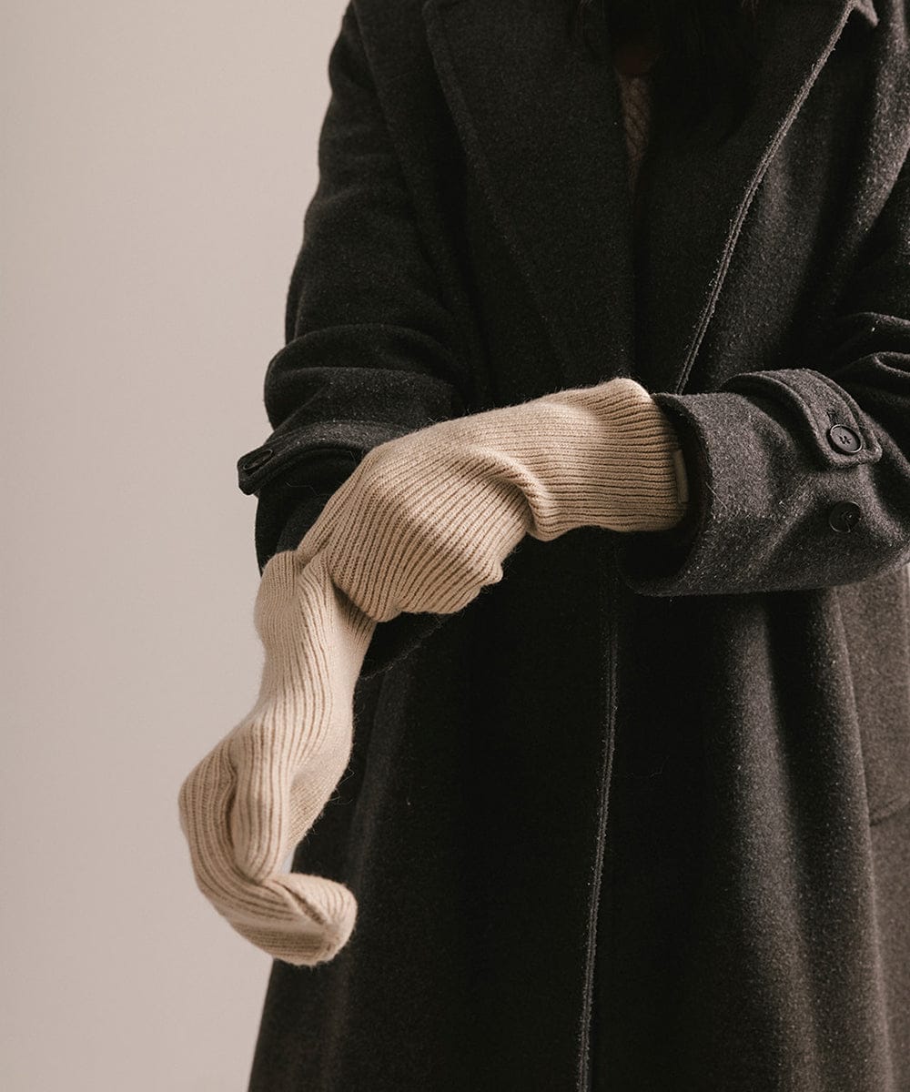 Close-up of a dark coat with beige gloves on a neutral background #color_taupe