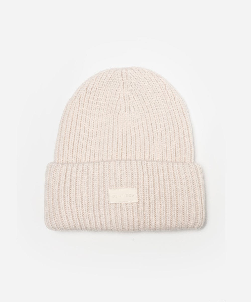 Beige knit beanie with a logo patch on a light gray background #color_off white