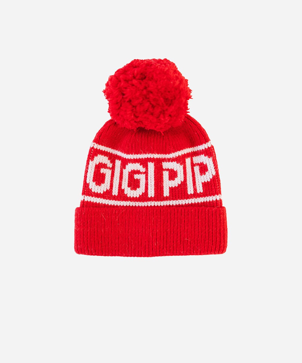 A ruby red colored knit beanie with pom-pom and 'GIGI PIP' branding on a white background #color_ruby red