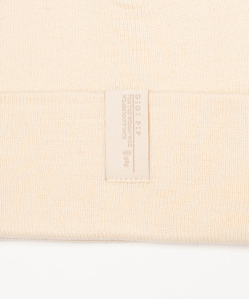 Beige fabric with a brand label on a white background #color_cream