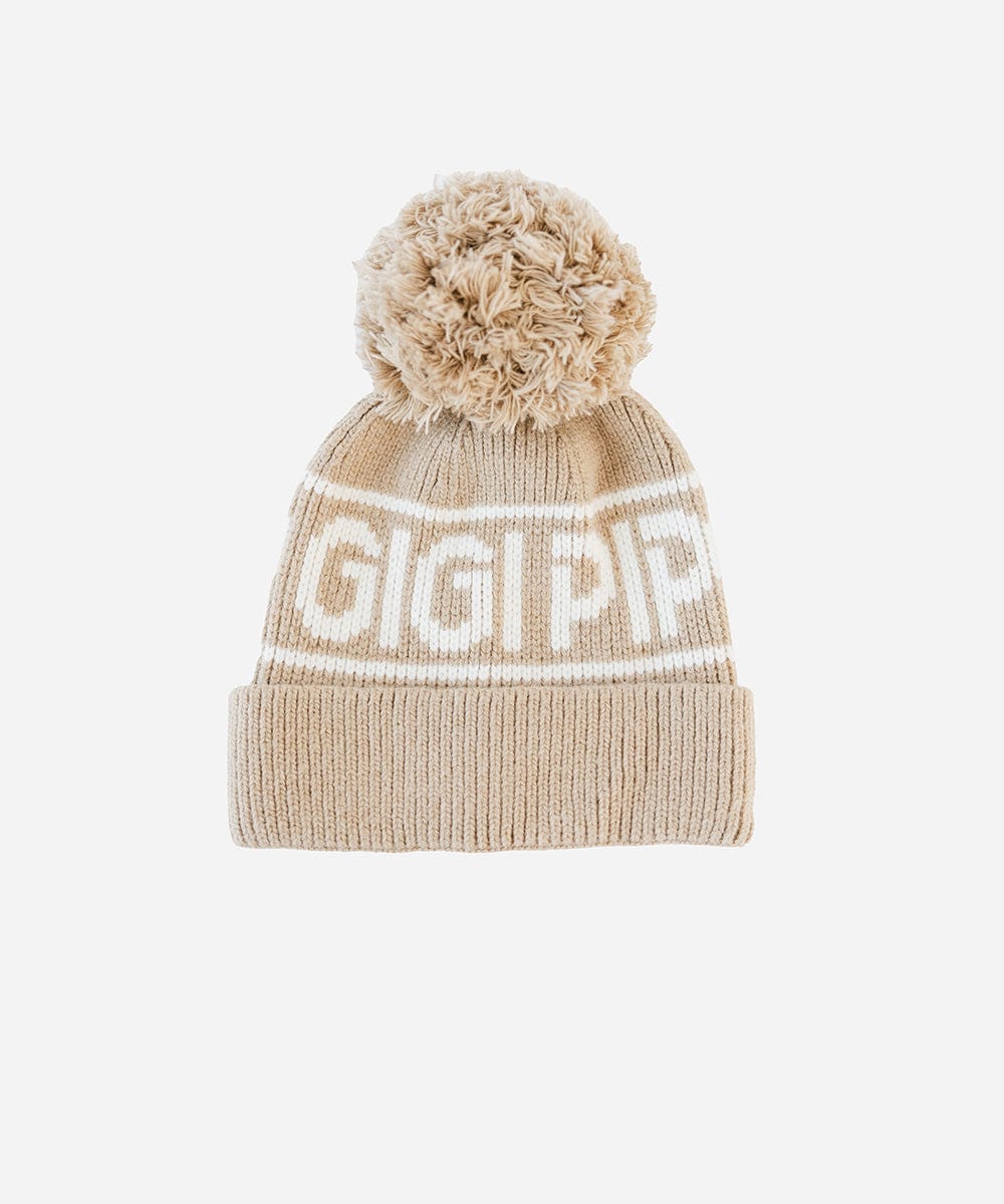A taupe colored knit beanie with pom-pom and 'GIGI PIP' branding on a white background #color_taupe