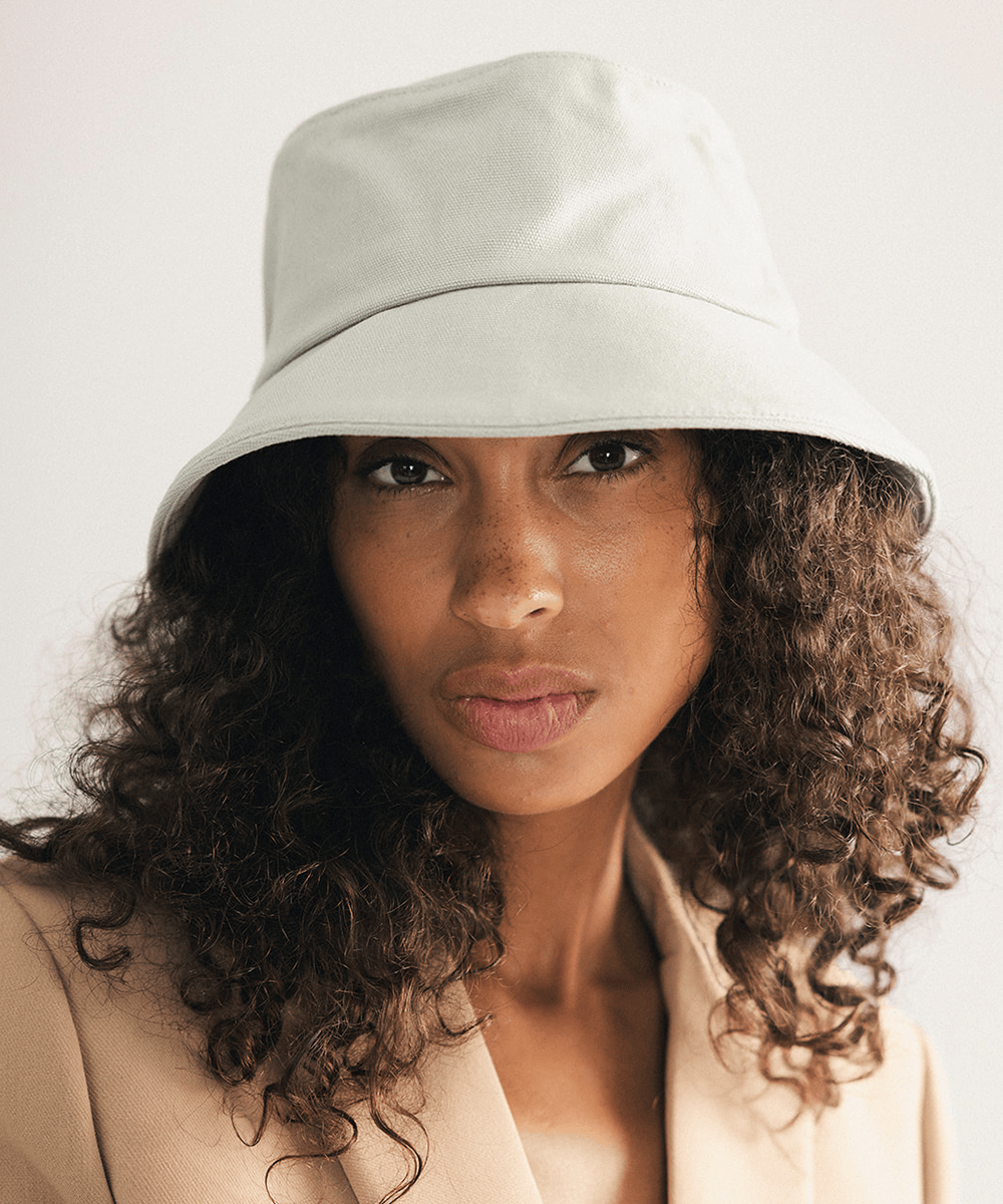 Woman wearing a sage bucket hat with a plain background #color_sage