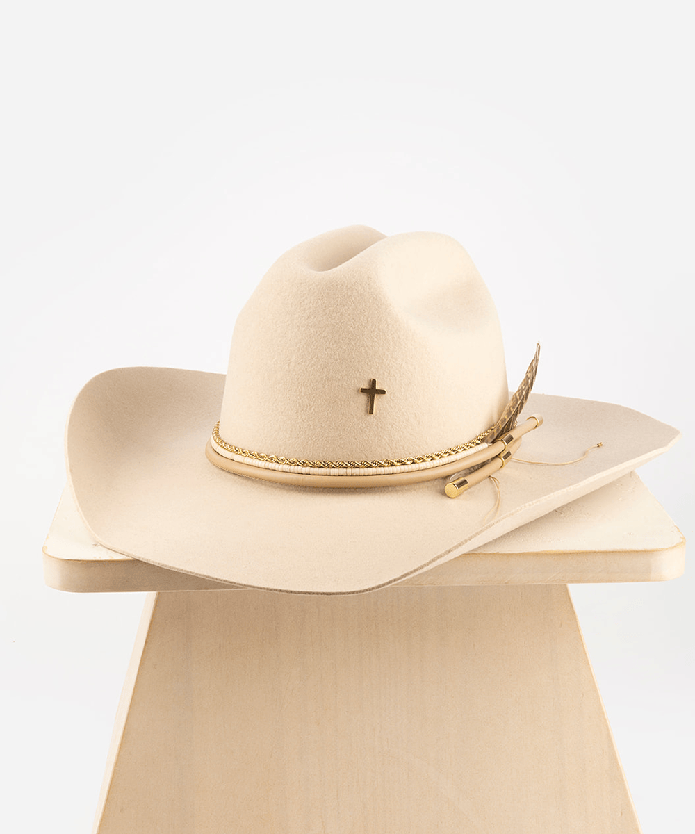 Beige cowboy hat with cross and feather on a white background #color_gold