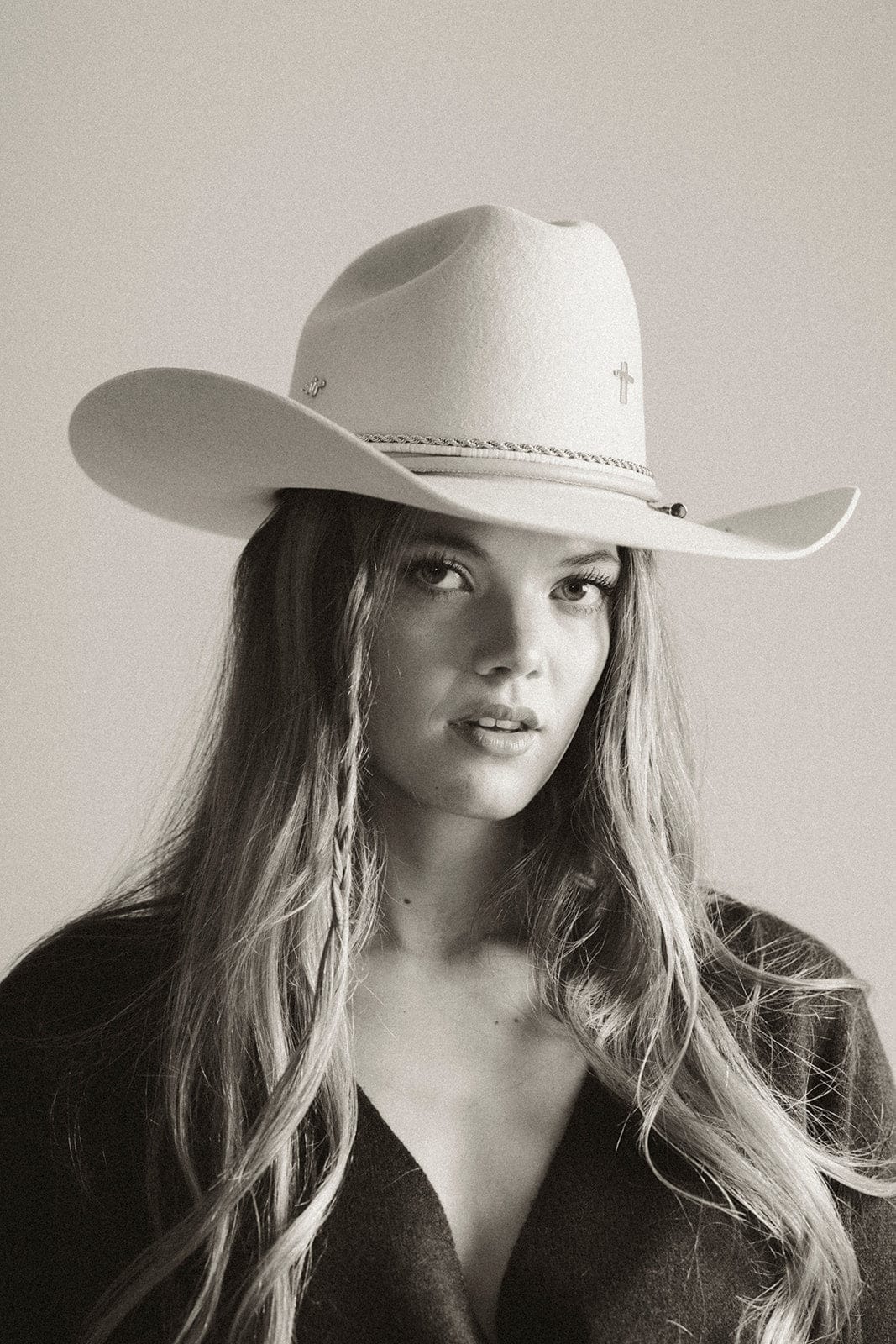 Black and white photo of a person wearing a cowboy hat #color_silver