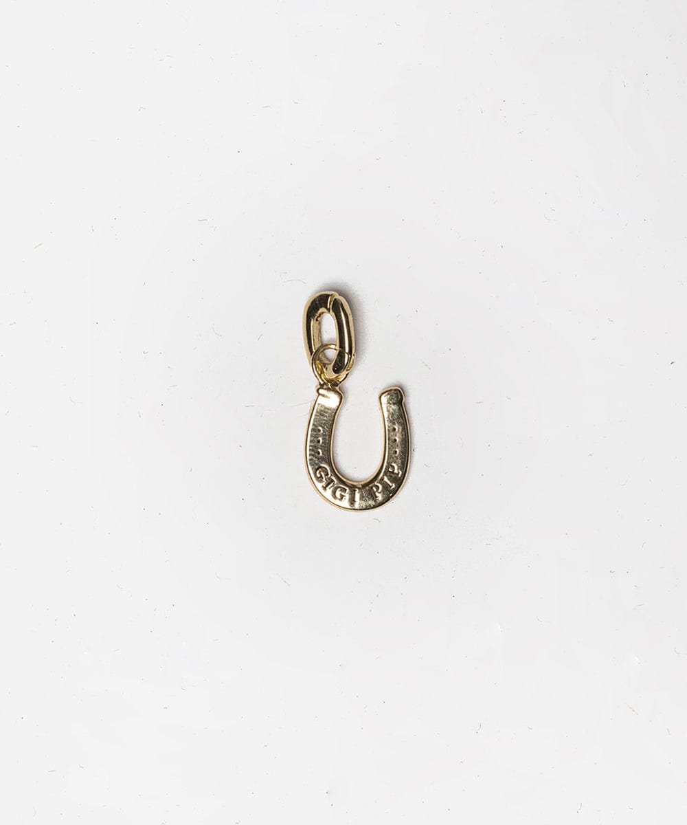A gold horseshoe hat charm on a white background #color_gold