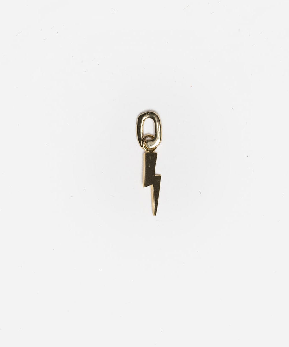 A gold lightning bolt hat charm on a white background #color_gold