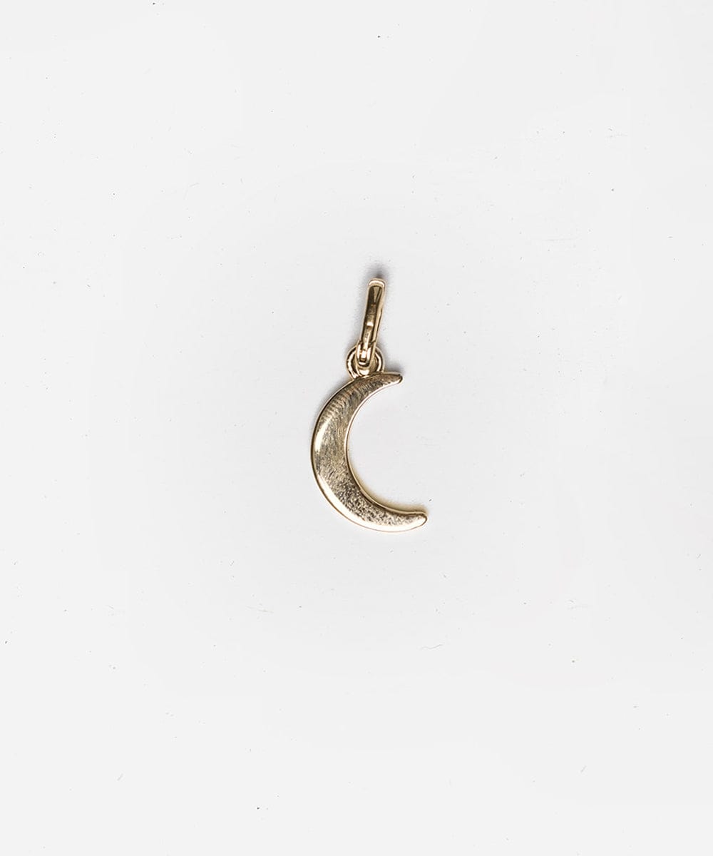 A gold moon hat charm on a white background #color_gold