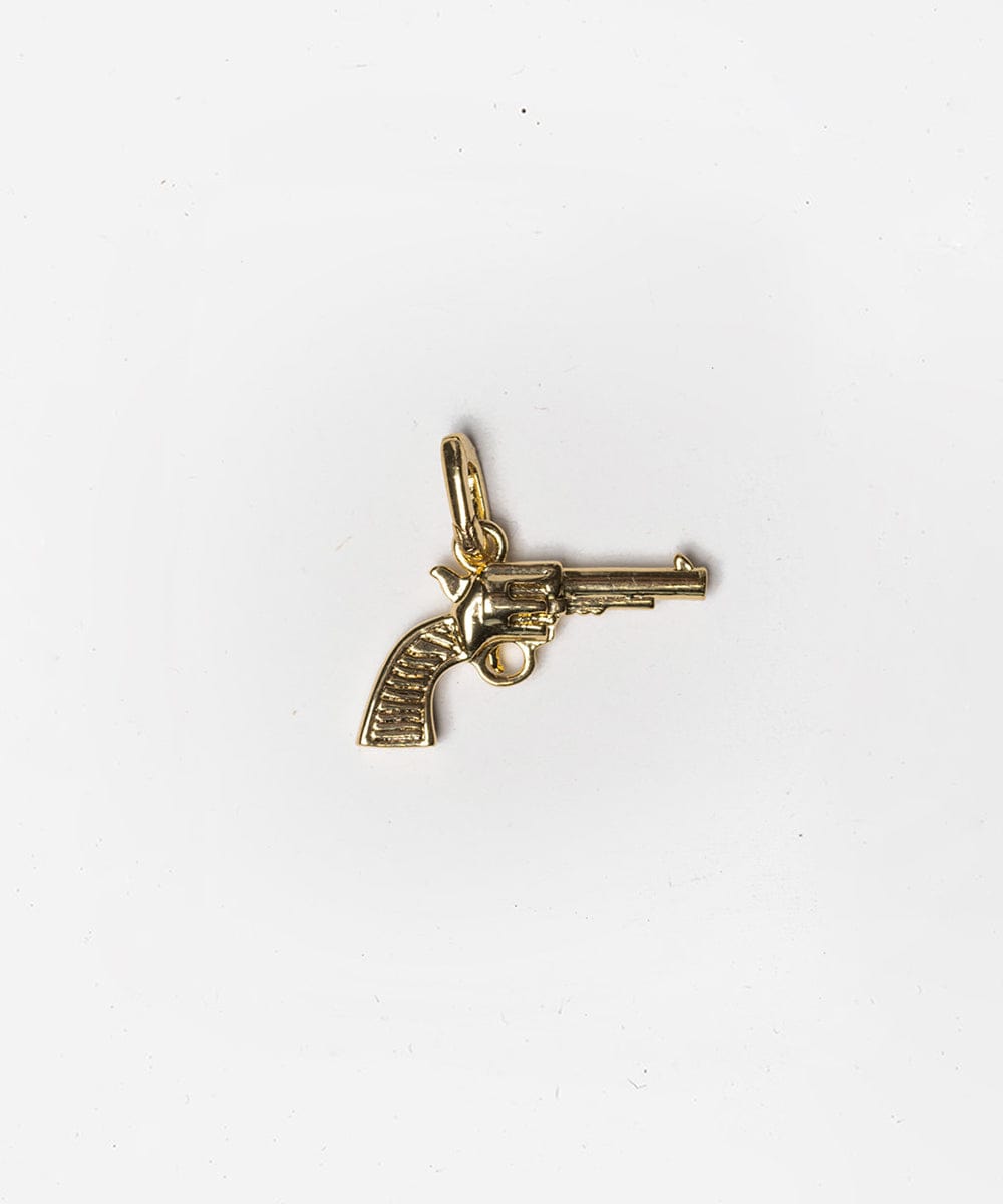 A gold pistol hat charm on a white background #color_gold