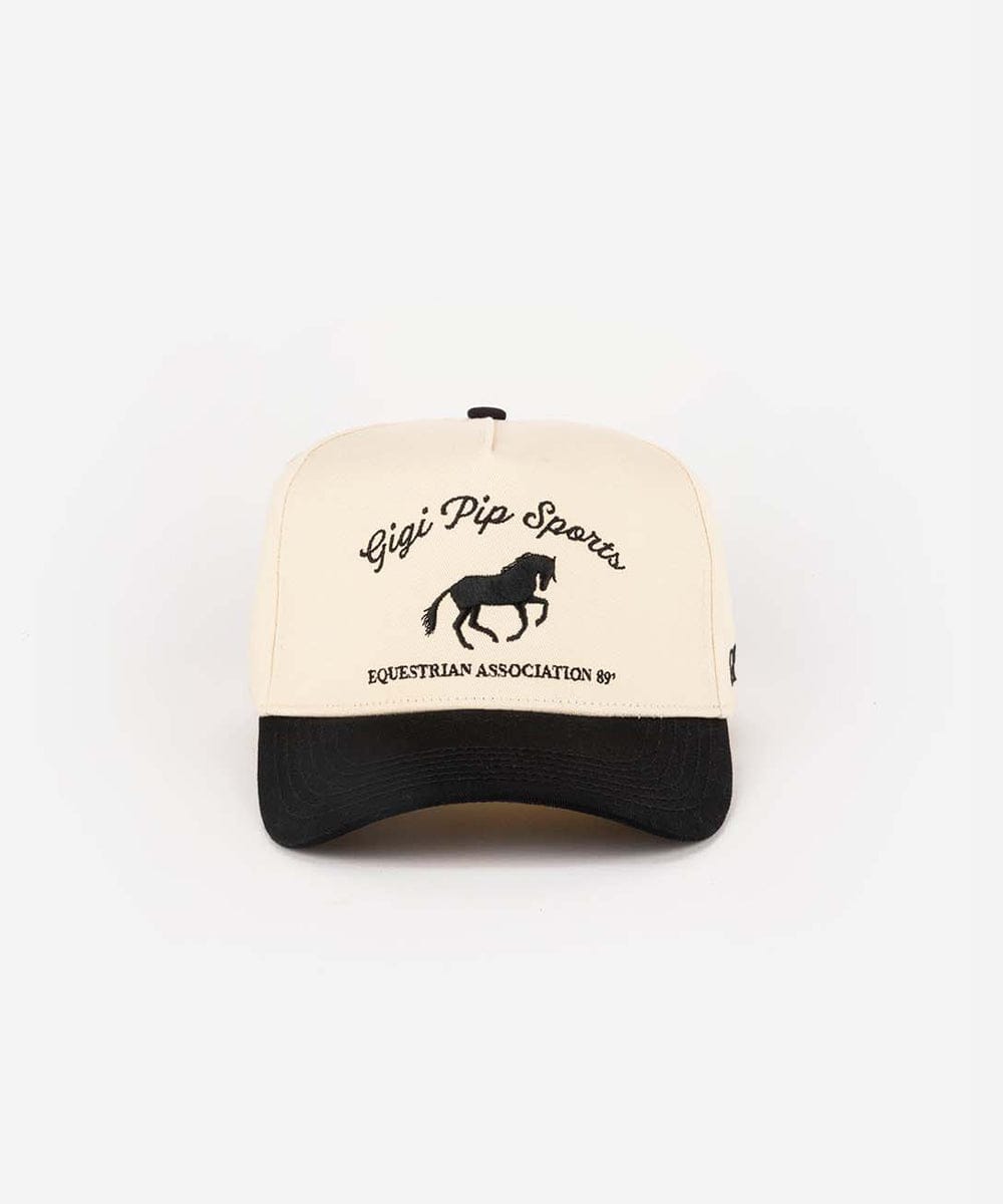 Trucker hat with 'Gigi Pip Sports Equestrian Association' text and horse logo on a white background #color_cream - black