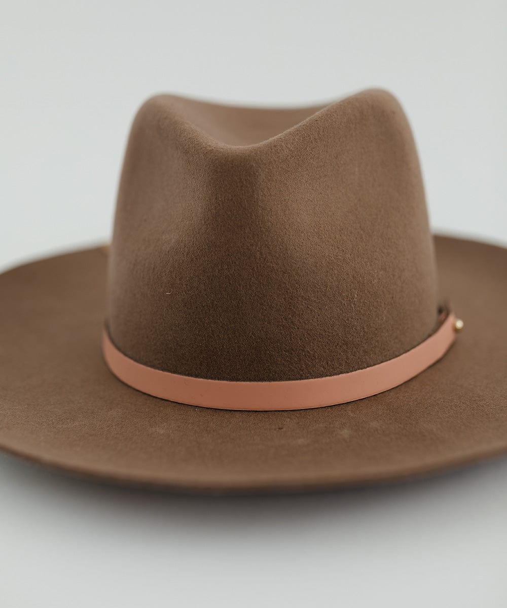 Close up image of a brown hat with a sunset colored genuine leather thin hat band against a plain background #color_sunset