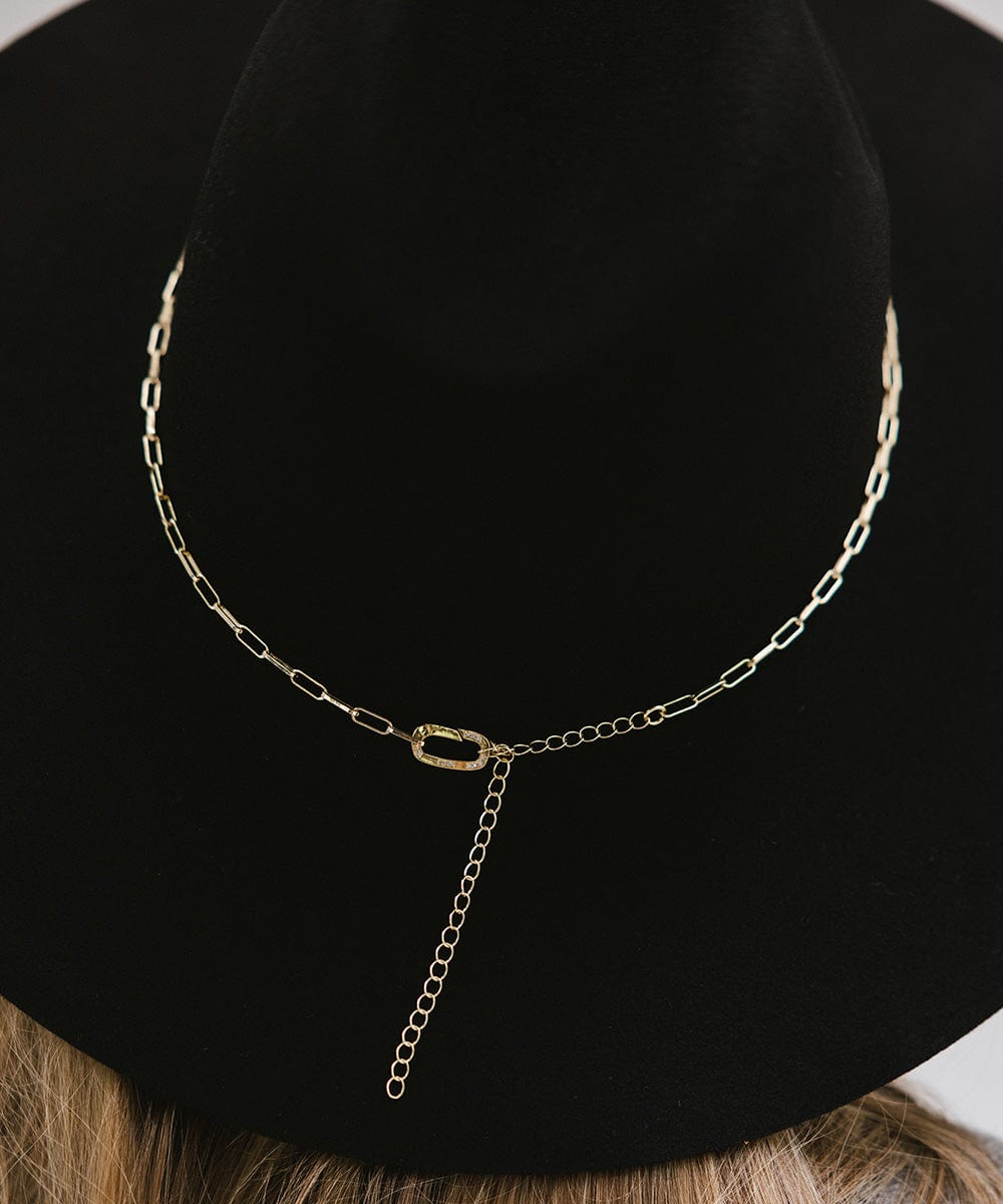 Close up image of a black wide brim hat with a gold paperclip chain hat band #color_gold