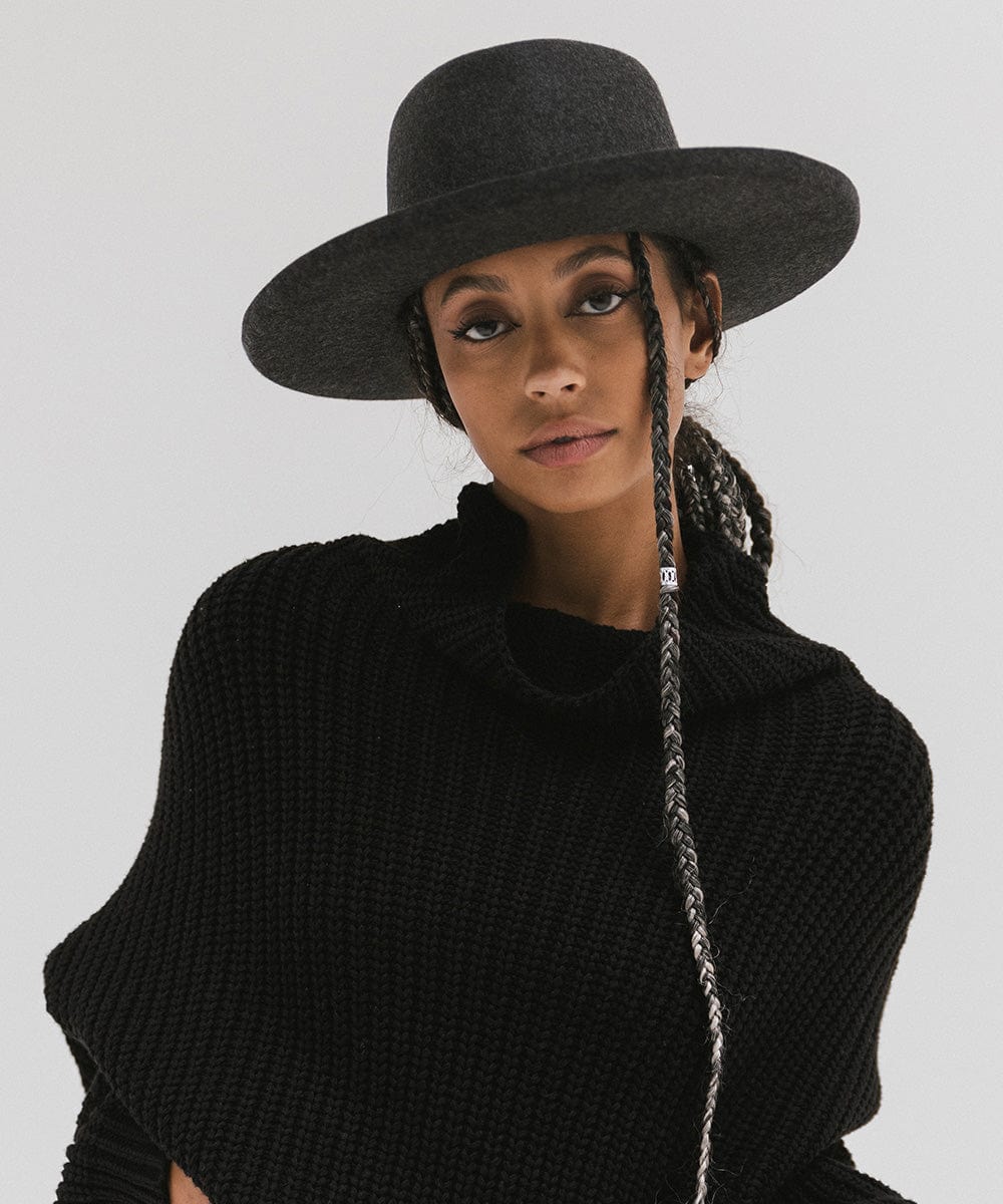 Woman wearing a mix charcoal colored Lennon pencil brim fedora hat and a black sweater against a plain background #color_mix charcoal