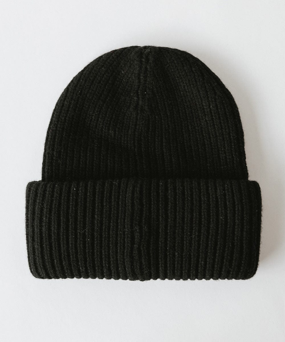 A black ribbed beanie on a plain background #color_black