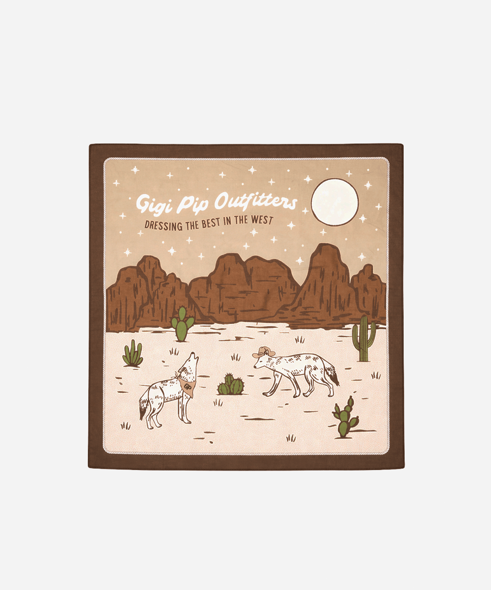 Chocolate colored bandana with a desert scene with mountains, cacti, and two animals with 'Gigi Pip Outfitters' branding on a white background #color_chocolate