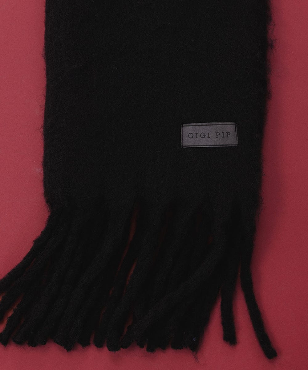 A black knit scarf with fringes on a red background #color_black