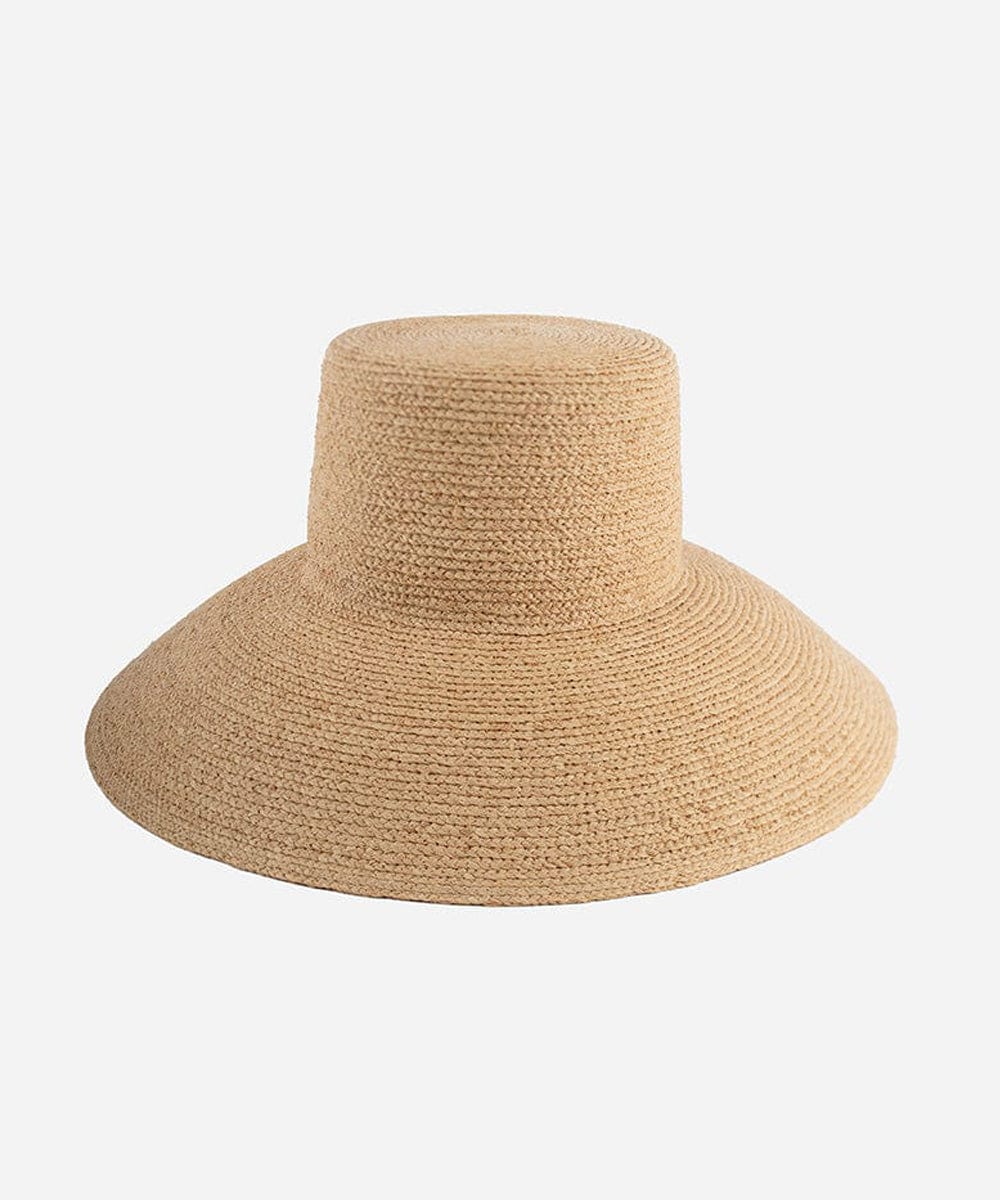 A natural colored oversized raffia straw bucket hat with a wide brim. #color_natural
