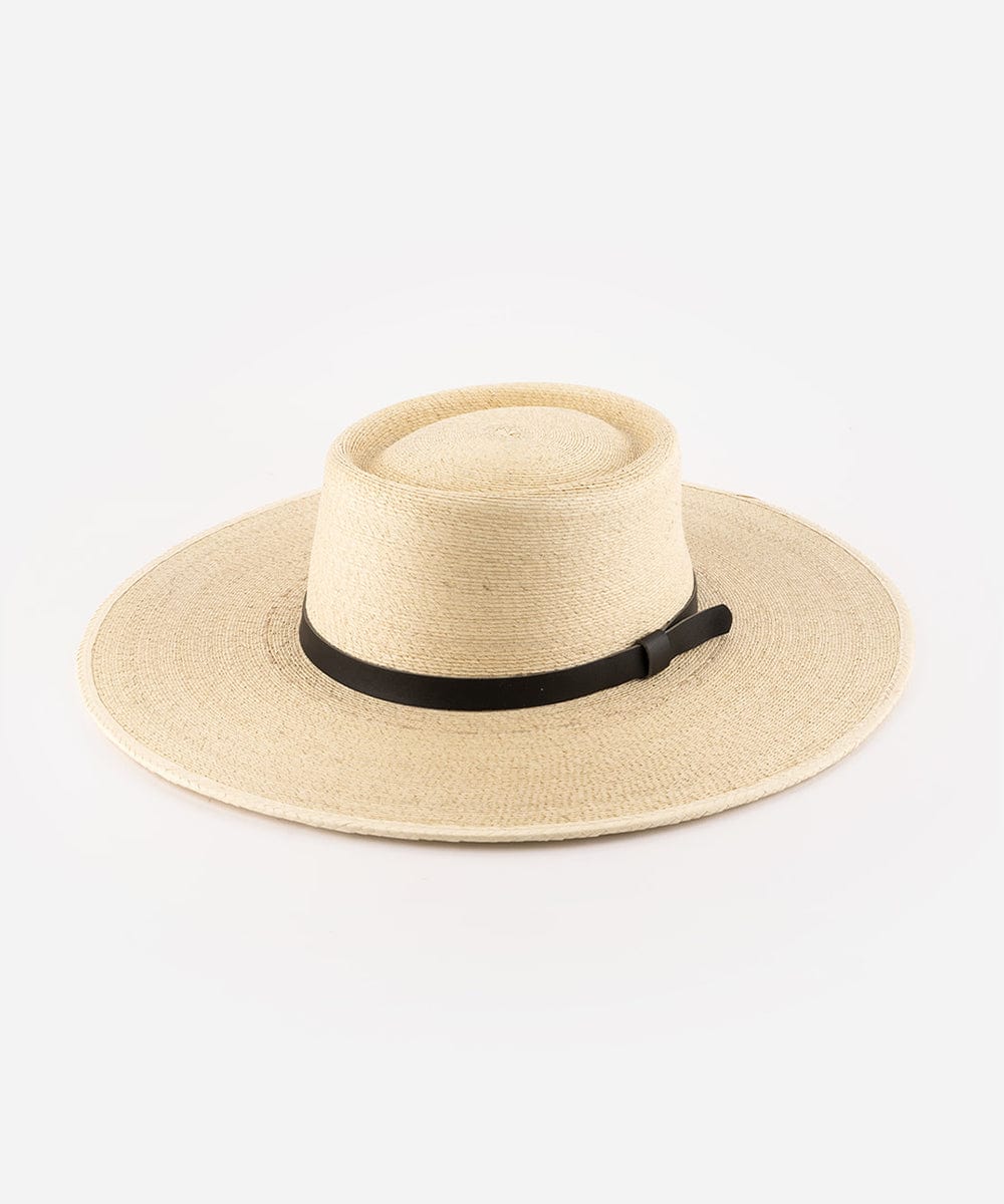A natural colored straw boater hat with a wide brim, featuring a black genuine leather band. #color_natural