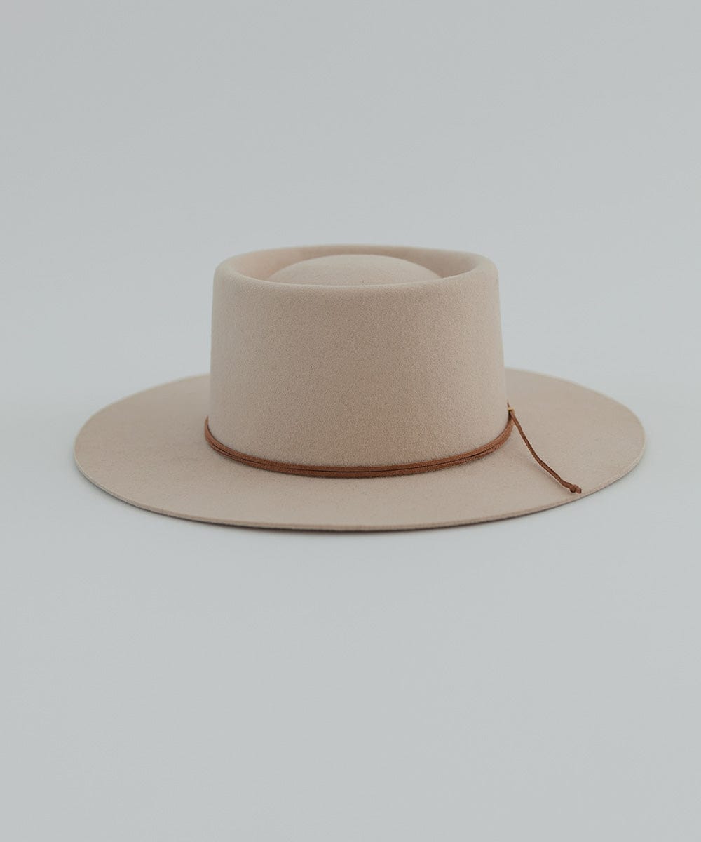 A cream hat with a brown suede band on a plain background #color_brown