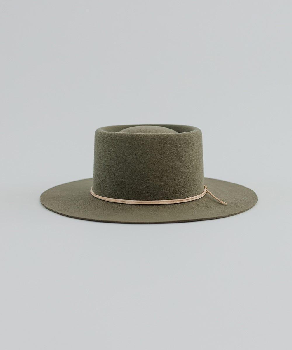 An olive hat with a cream suede band on a plain background #color_cream