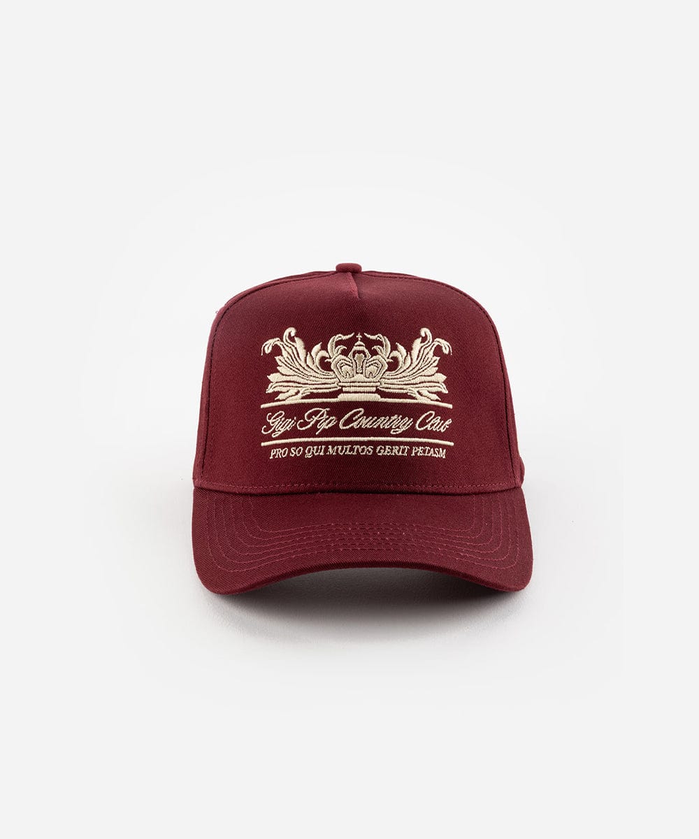 A burgundy vintage trucker cap with a white logo and the text 'Gigi Pip Country Club', displayed against a plain background #color_burgundy