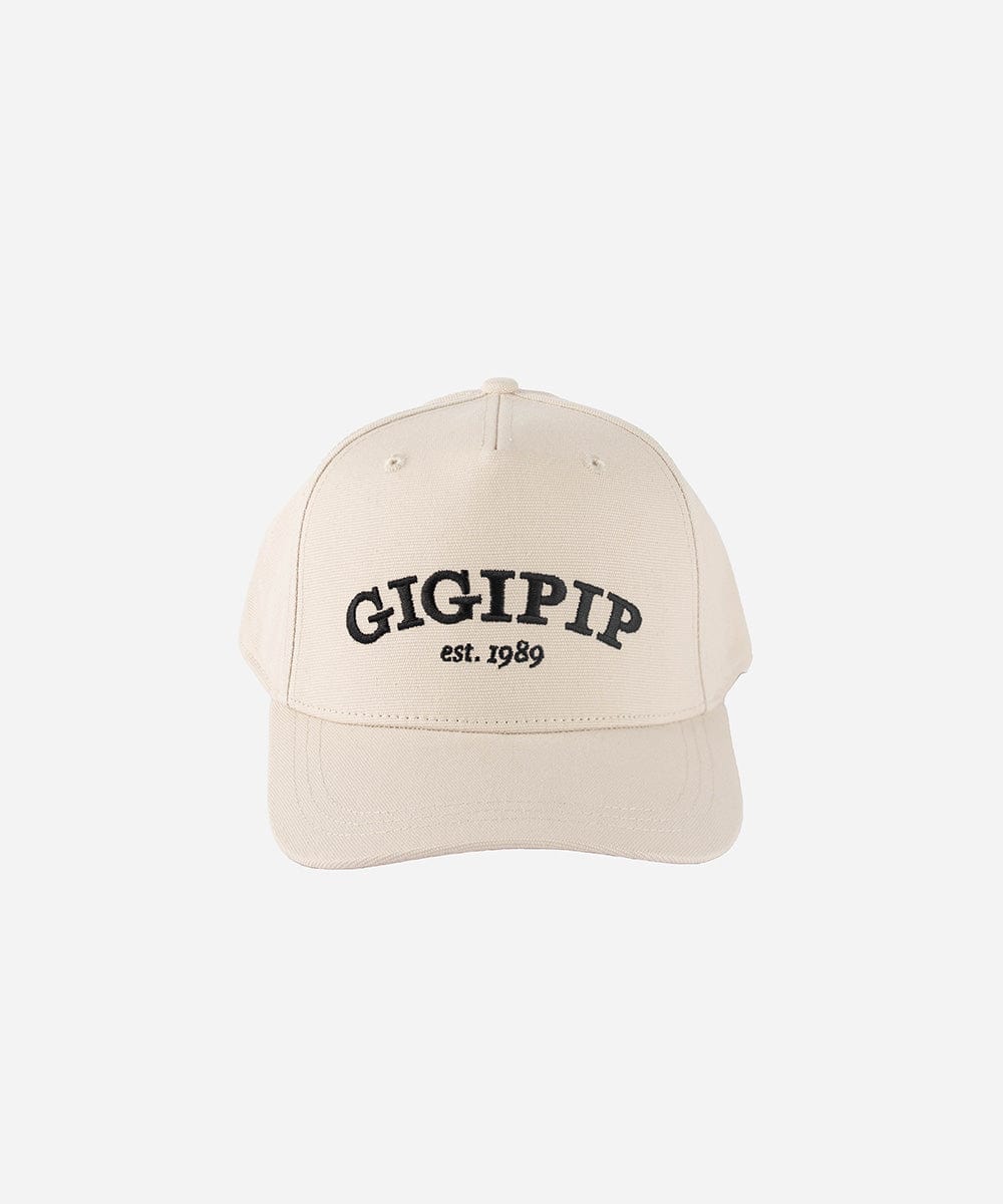 A cream trucker hat with 'GIGI PIP' embroidered in black on the front against a plain background #color_cream