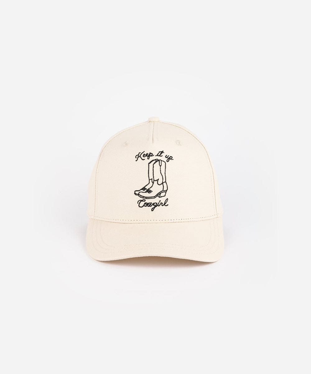 A cream cap with black text and boot design on a white background #color_cream