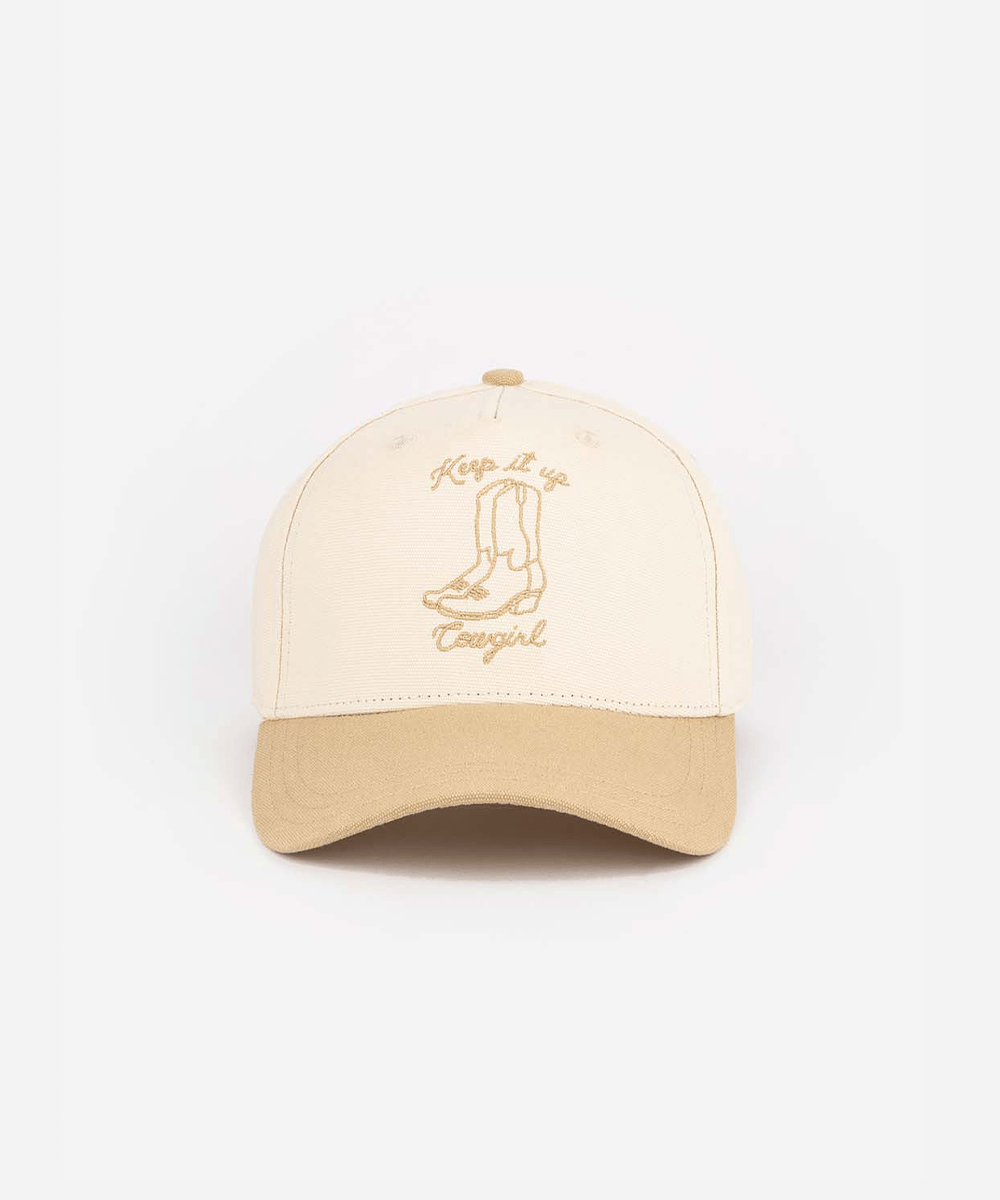 A cream and tan cap with tan text and boot design on a white background #color_cream - tan