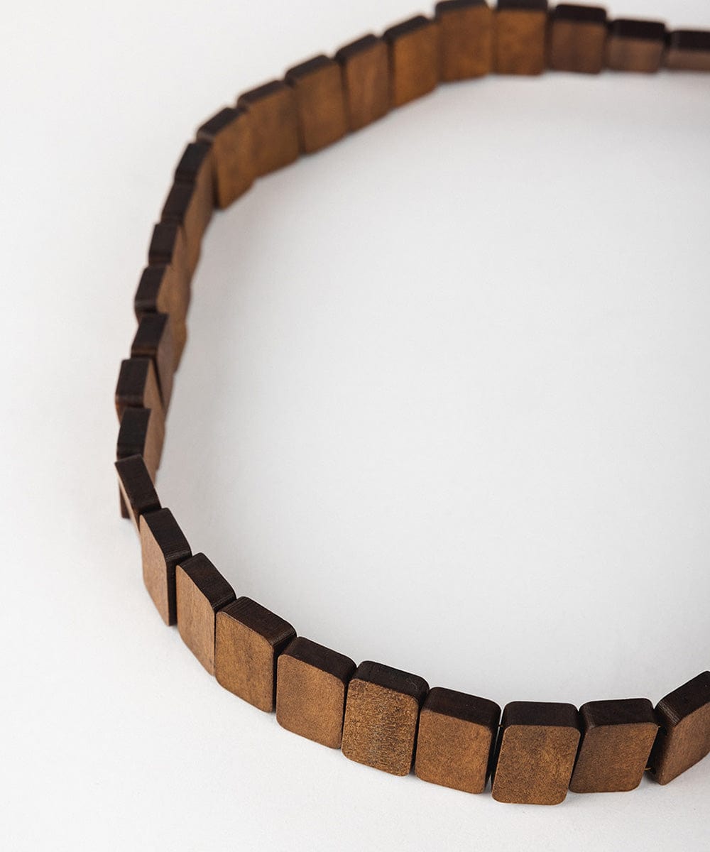 A brown wooden beaded band on a plain background #color_brown