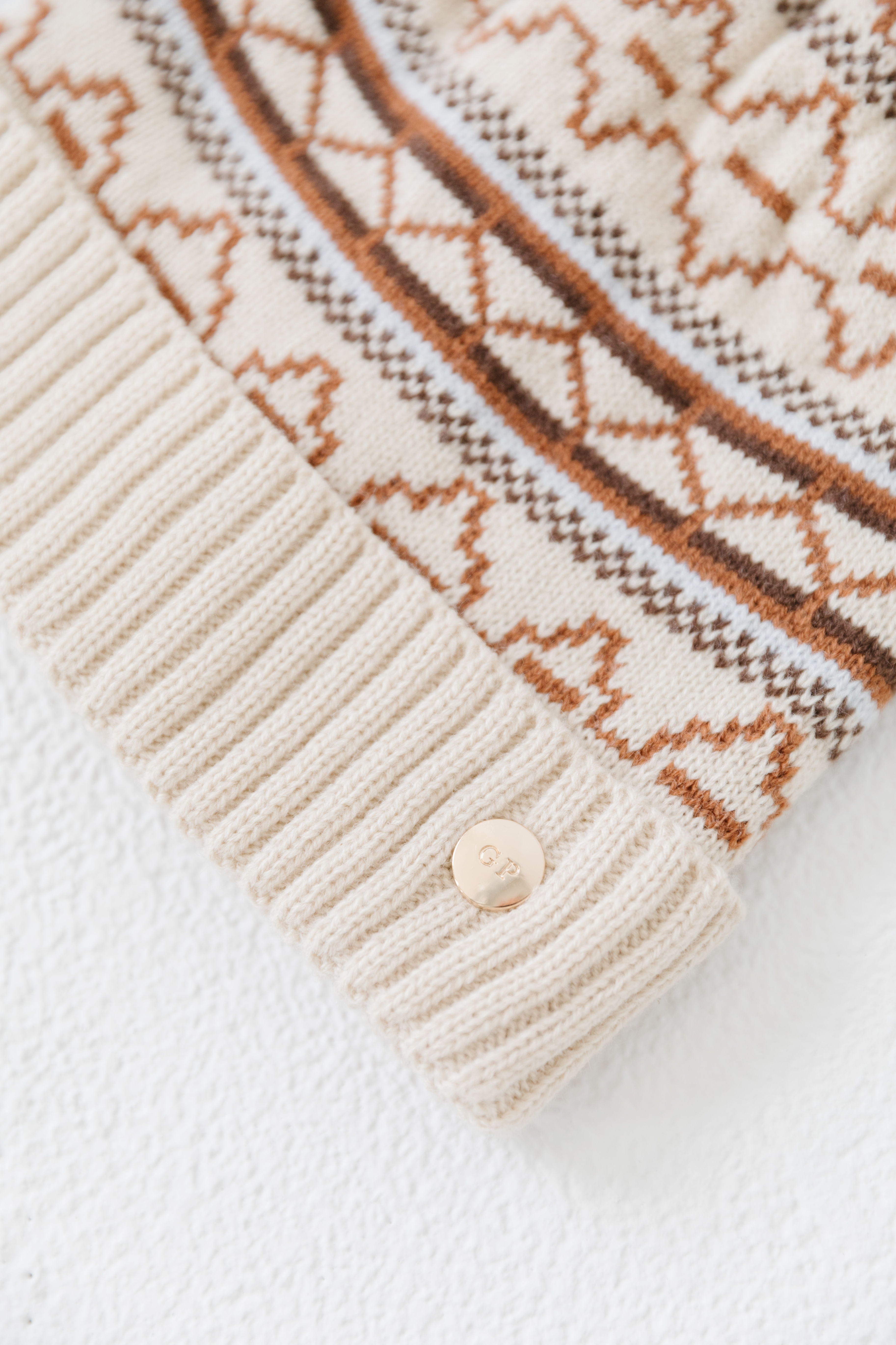 Close up image of a printed knit beanie on a plain background