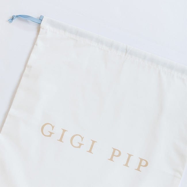 A white bridal keepsake duster bag with the text 'GIGI PIP' on a plain background #color_white