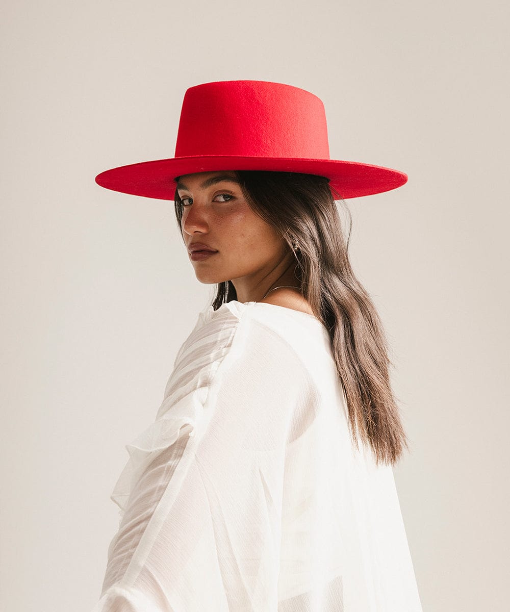 Woman wearing a red hat against a plain background #color_cherry red