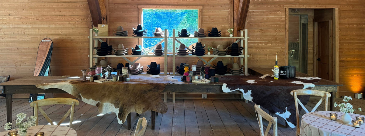 Wooden interior with shelves displaying various items and a large window at a custom hat bar event.