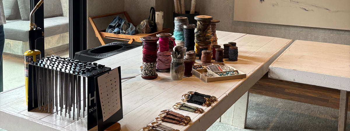 Collection of decorative items on a table in a modern interior setting at a custom hat bar event.