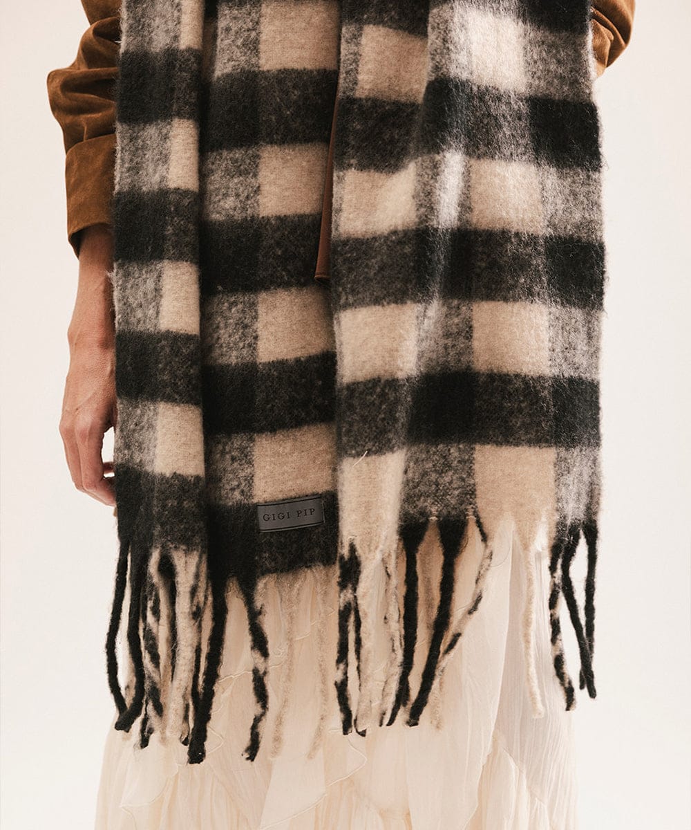 Plaid scarf with fringes and a visible brand label on a neutral background #color_Black - Cream Buffalo Check