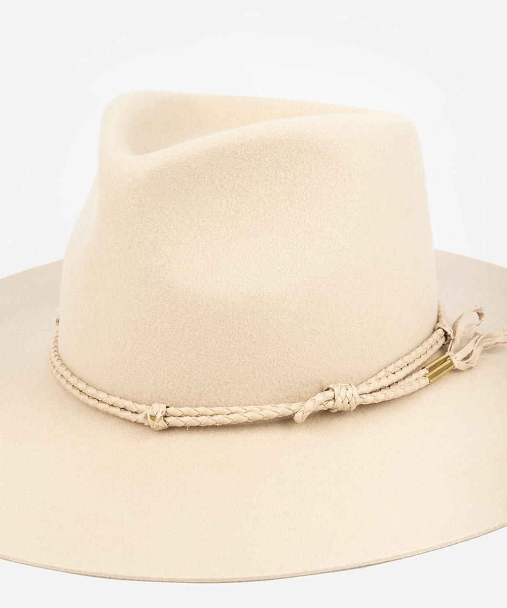 Beige fedora hat with decorative band on a light gray background #color_cream