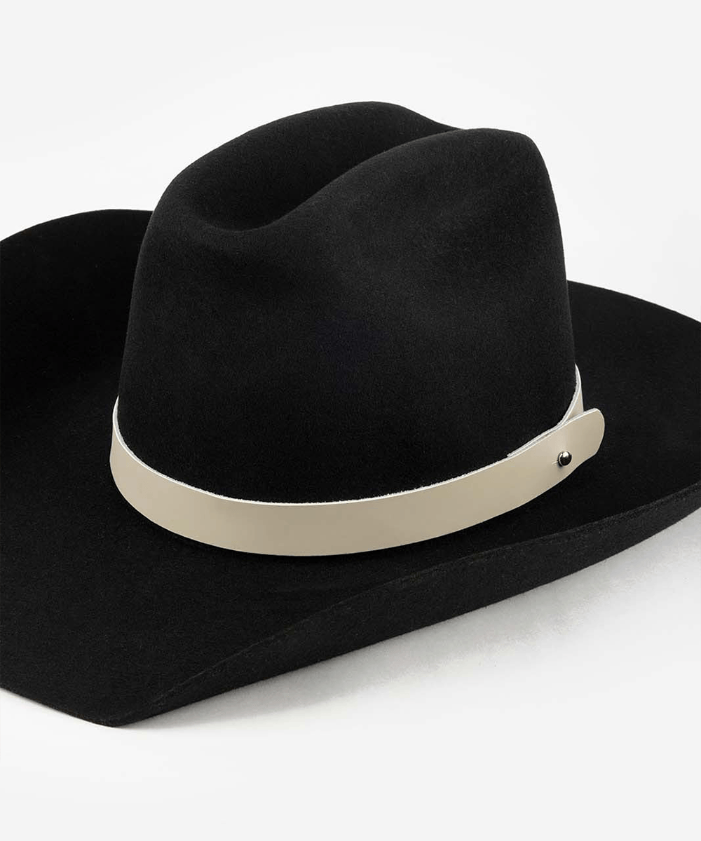 Black cowboy hat with a stone colored leather band on a white background #color_stone