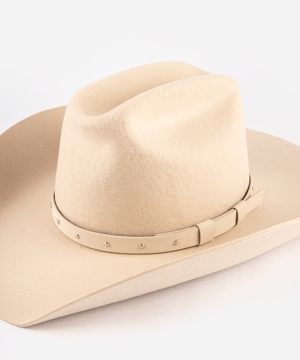 Beige cowboy hat with a band on a white background #color_cream-silver